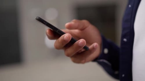 Crop Male Using Smartphone on Street