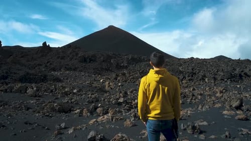 Man Traveler Walks Through the Lava Field Around Chinyero Volcano in the Teide National Park on the