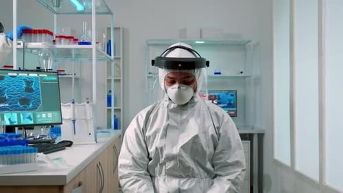 Scientist in Full Protective Gear in Bright Laboratory