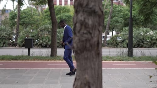 Smiling businessman walking in city