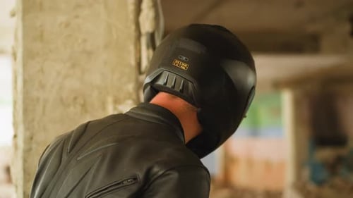 Person in Helmet Looks at Criminals and Hostage in Building