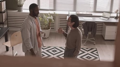 Adults Talking and Drinking Coffee in Office