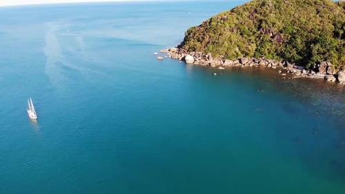 Boat Near Tropical Shore. Amazing Drone View of Modern Yacht Sailing on Calm Sea Water Near Coast