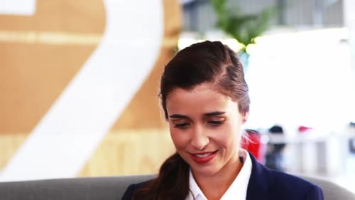 Smiling Businesswoman Using Tablet in Modern Office