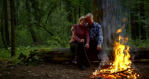 Loving Couple by Forest Campfire