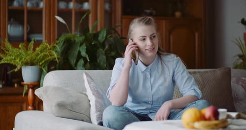 Woman Talking on Cell Phone in Living Room