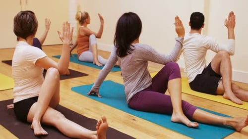 Yoga Class Stretching and Twisting Indoors