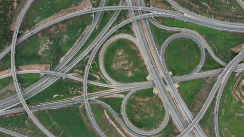 Aerial View. Highway, Multi-level Junction Road with Moving Cars. Cars Are Moving on a Multi-level