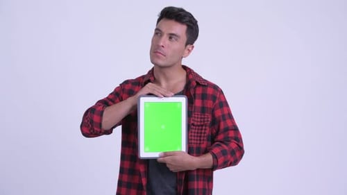 Smiling Man Holds Tablet with Green Screen