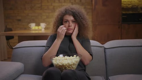 Woman Watching a Scary Movie at Home