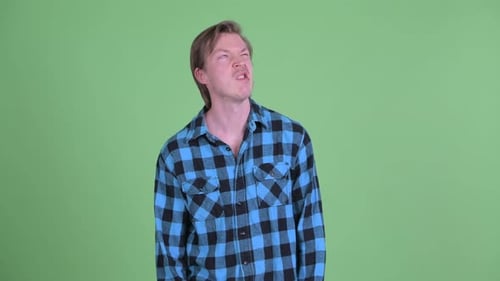 Young Adult Man Making Faces in Studio