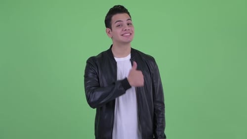 Young Adult Gives Thumbs Up on Green Screen