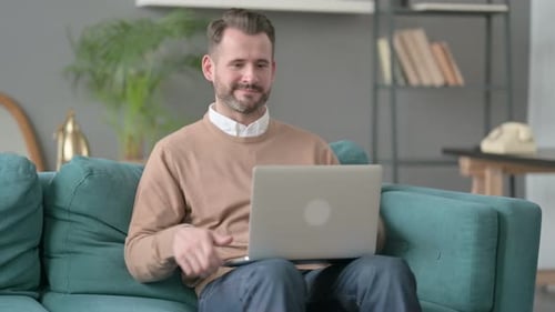 Man Closing Laptop Leaving Sofa