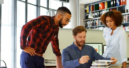Architects Discussing Over Building Model at Desk