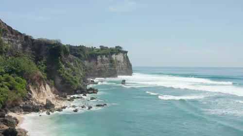Wild Steep Rocky Cliffs and Blue Ocean in Bali Indonesia