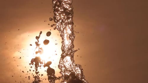 Water Stream Splashing in Golden Sunlight