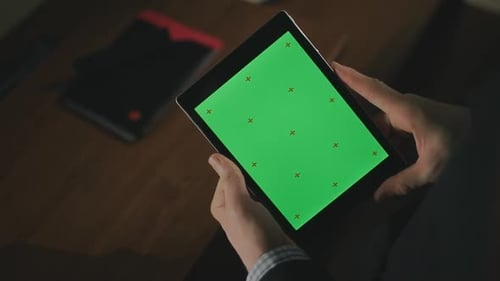 Male Hand Using Tablet Pc with Green Screen. Male Finger Touching Tablet Screen