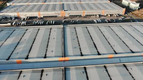 Motion Above Warehouses Roofs and Big Trucks Parking Lot
