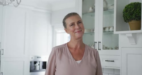Woman Smiling in Bright White Kitchen