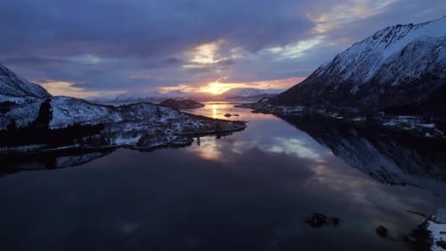 Majestic Snowy Mountains Reflecting Golden Sunrise in Lake