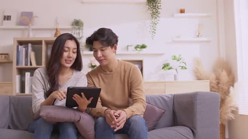 Couple Relaxing with Tablet in Modern Living Room