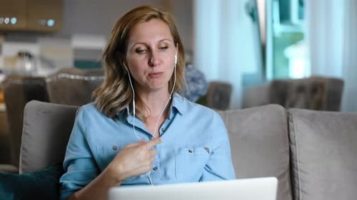 Woman Talking on Laptop Video Call at Home