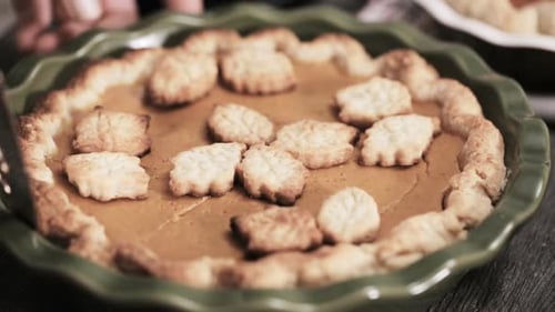 Fresh Pumpkin Pie Being Sliced and Served
