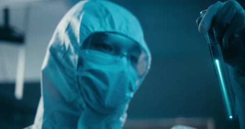 Scientist Examining Sample in Laboratory