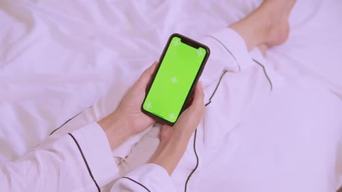 Hands Holding Phone with Chroma Key Screen