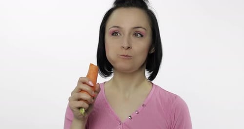 Woman Eating Raw Carrot for a Healthy Snack