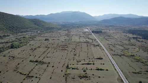 Empty Asphalt Road on the Plateau Between Green Fields Highland Way Aerial View