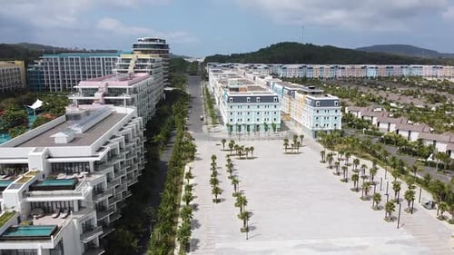 Aerial View of the Blue Ocean on an Island with White Sand a Resort with Hotels and Palm Trees