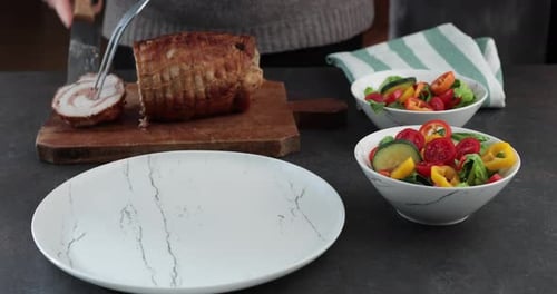 Slicing Roasted Meat Roll with Knife and Fork