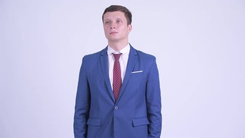 Young Businessman Smiling in a Blue Suit