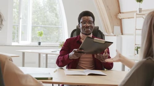 Man Shaking Hands with Colleagues in Office