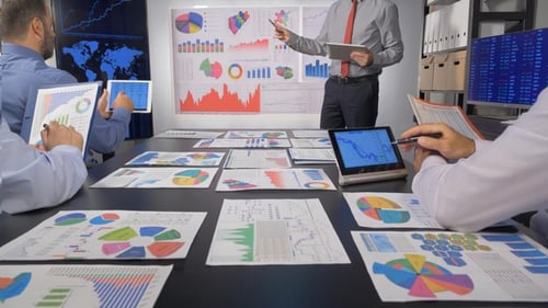 Team Analyzing Financial Charts in an Office Meeting