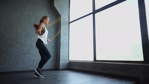 Woman Skipping Rope for Fitness Indoors