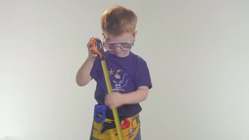Young Boy Playing with a Tape Measure