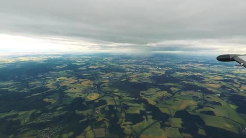 Villages Surrounding Fields with Forests - Cloudy Sky - Aerial View From Airplane
