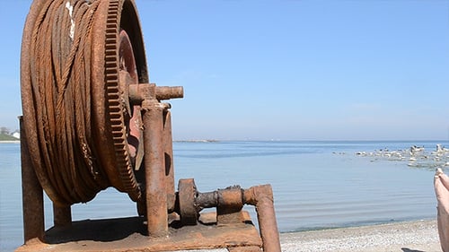 Old Rusted Winch on Rocky Ocean Beach