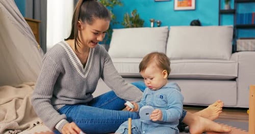 Woman and Baby Playing Together at Home