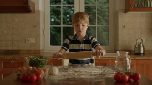 Kid Rolling Dough Standing in the Kitchen
