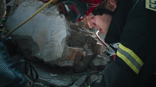 Focused Rescue Worker Searching Through Rubble After Disaster