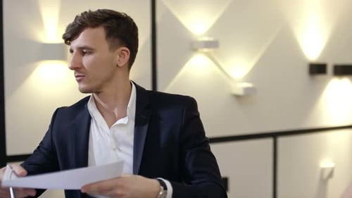 Young Adult Receives Documents Indoors