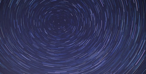 Swirling Star Trails Forming Cosmic Vortex on Blue