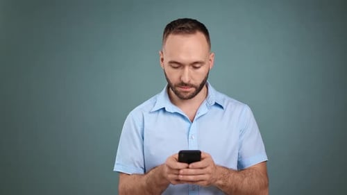 Man Using Smartphone, Typing Message Indoors