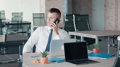 Young Adult Man Working at Laptop in Office