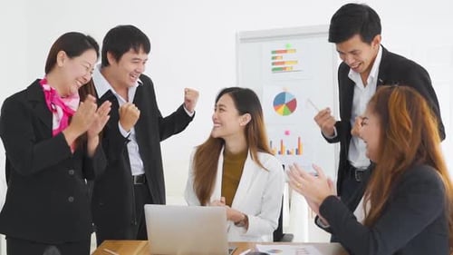 Enthusiastic Business Team Celebrating Success in Office