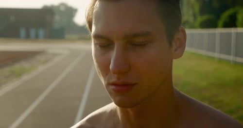Athletic Man On Running Track At Sunrise