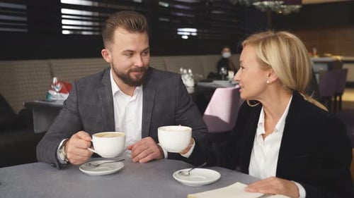Business Meeting with Coffee in Restaurant Setting